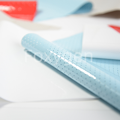 Perforated stretched fabric acoustic ceiling for reducing room reverberation