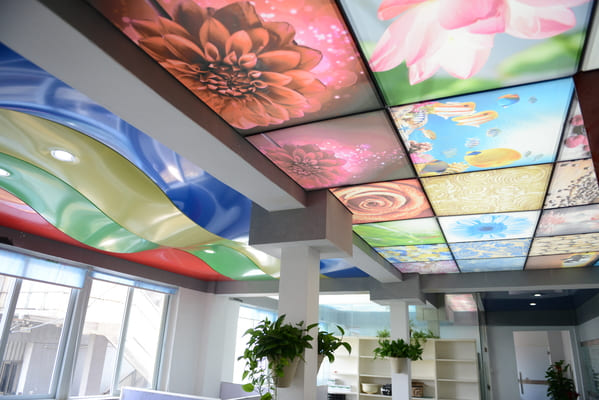 How a stretched fabric acoustic ceiling absorbs sound through perforations and cavity resonance